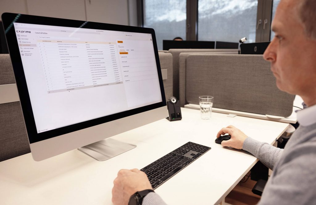 Mitarbeiter vor dem Laptop beim Arbeiten mit einer Buchhaltungssoftware für Handwerker